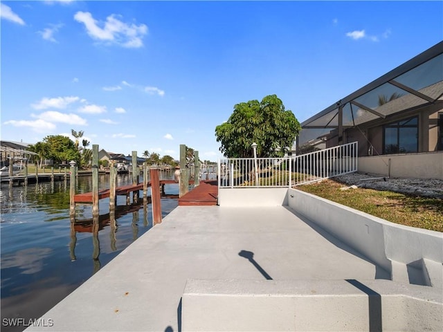 view of dock with a water view and glass enclosure