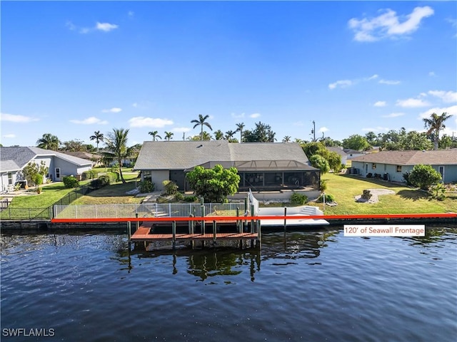 view of dock featuring glass enclosure, a water view, and a yard