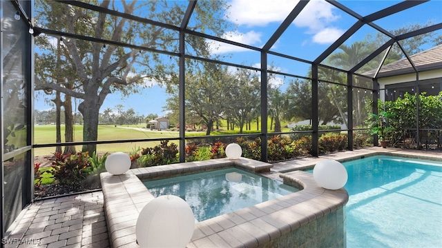 view of swimming pool featuring a lanai