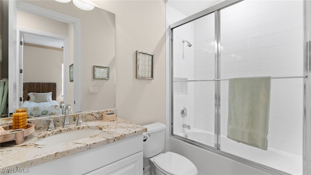 full bathroom with vanity, toilet, and enclosed tub / shower combo