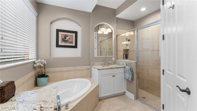 bathroom featuring tile patterned flooring, vanity, independent shower and bath, and plenty of natural light