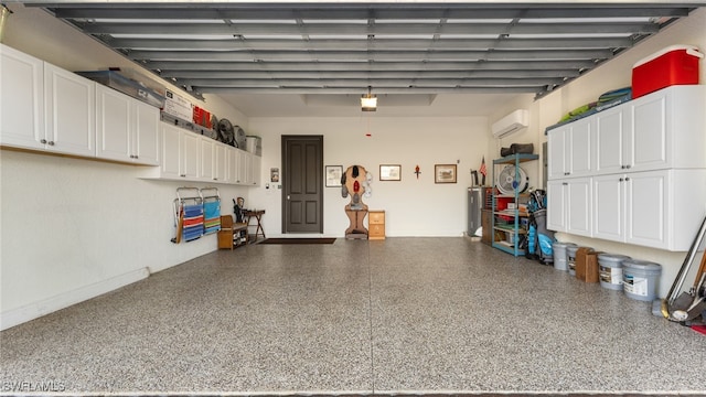 garage with a garage door opener and a wall mounted air conditioner