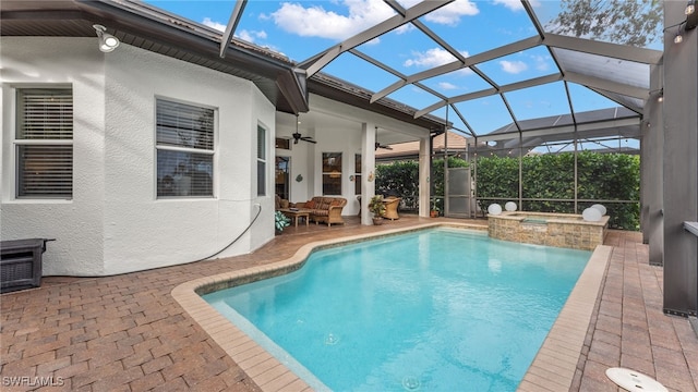 view of swimming pool featuring ceiling fan, glass enclosure, an in ground hot tub, and a patio