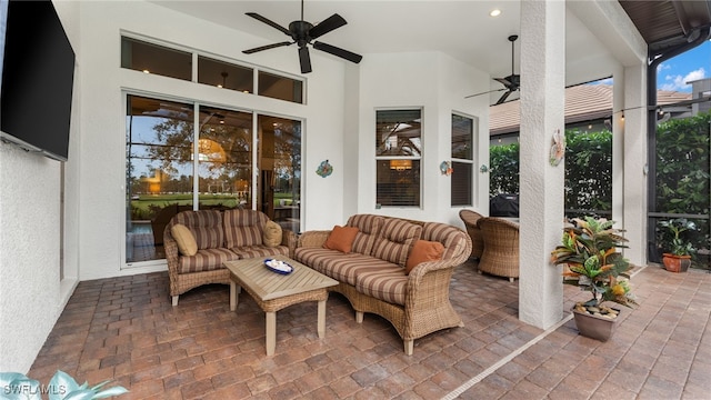 sunroom featuring ceiling fan