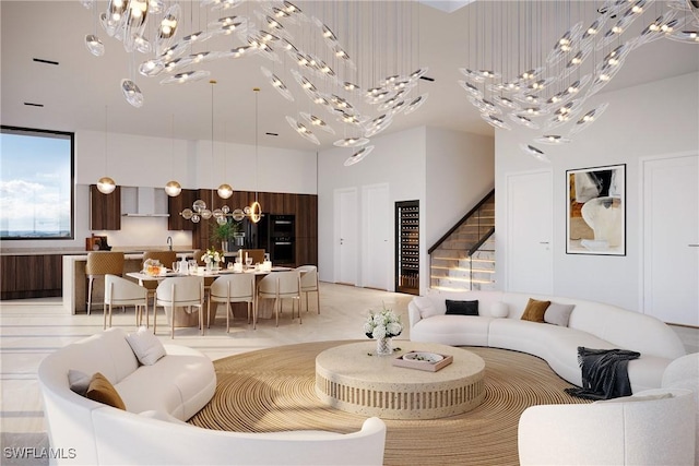 living room with a towering ceiling and a chandelier