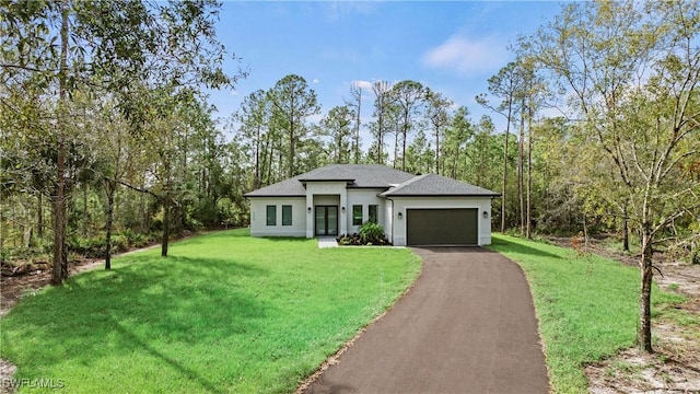 view of front facade with a garage and a front lawn