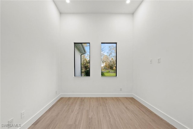 empty room with light hardwood / wood-style flooring