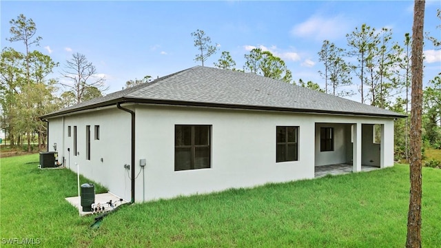 rear view of house featuring a yard, a patio, and cooling unit