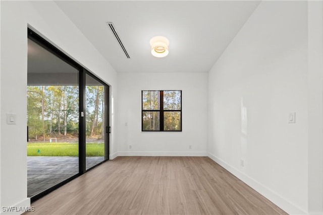 empty room with light hardwood / wood-style flooring