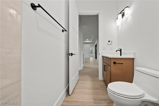 bathroom featuring hardwood / wood-style floors, vanity, and toilet