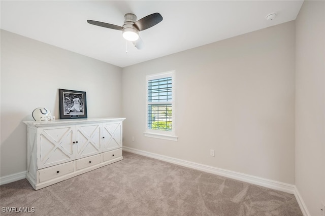 unfurnished bedroom featuring ceiling fan and light carpet