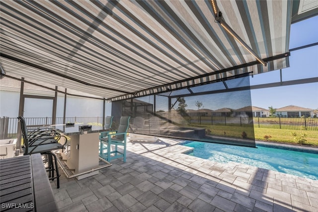 view of swimming pool with an outdoor bar and a patio