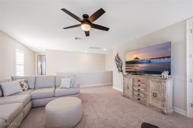 living room with ceiling fan and light colored carpet