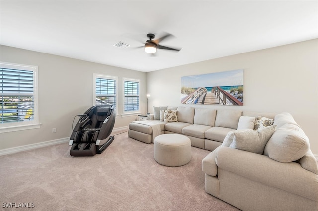 carpeted living room with ceiling fan