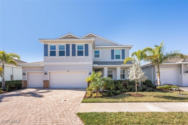 front of property featuring a front yard and a garage