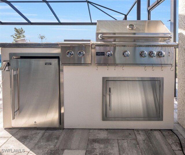 view of patio / terrace with area for grilling and glass enclosure