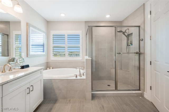 bathroom with separate shower and tub and vanity