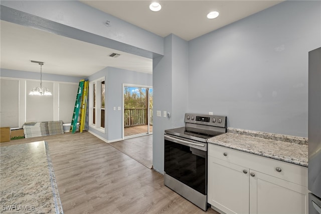 kitchen featuring white cabinets, light hardwood / wood-style flooring, an inviting chandelier, and stainless steel range with electric stovetop