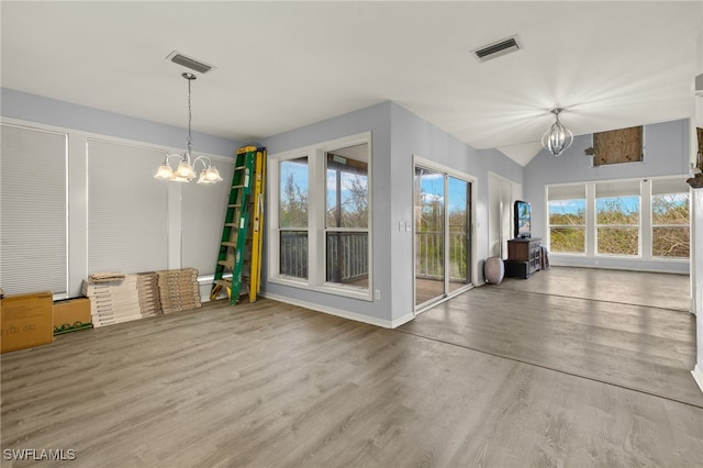 interior space featuring a chandelier, hardwood / wood-style floors, and a wealth of natural light