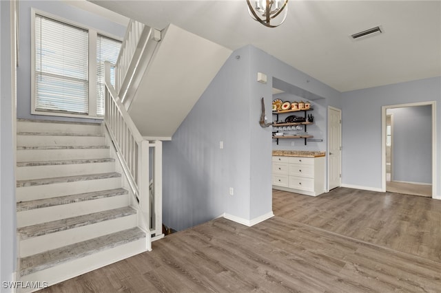 staircase with hardwood / wood-style floors