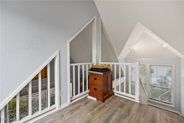 bonus room featuring hardwood / wood-style floors and high vaulted ceiling