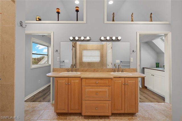 bathroom with vanity, high vaulted ceiling, and hardwood / wood-style flooring