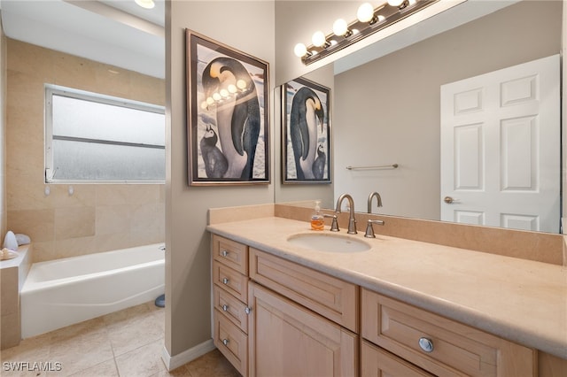 bathroom with tile patterned flooring, a bath, and vanity