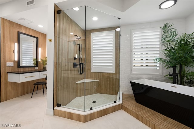 bathroom featuring shower with separate bathtub and tile patterned floors