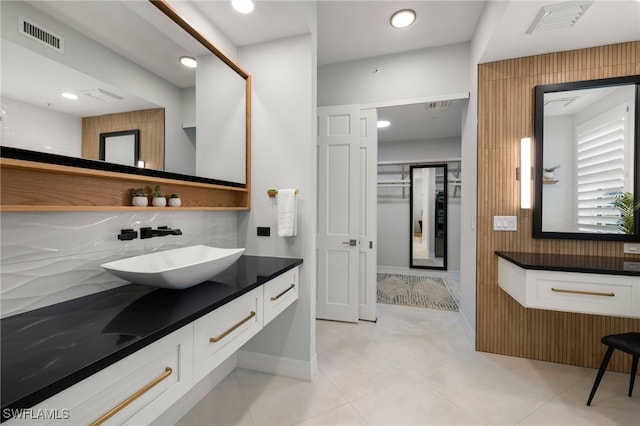 bathroom with backsplash, tile patterned flooring, and vanity