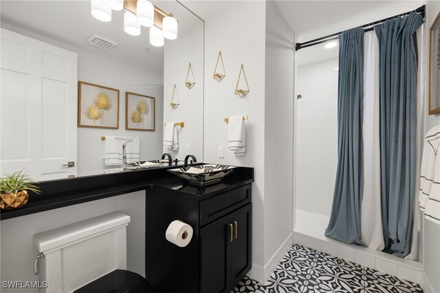 bathroom featuring vanity, tile patterned floors, and walk in shower