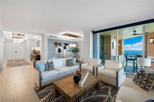 living room featuring light wood-type flooring, expansive windows, ceiling fan, crown molding, and a water view