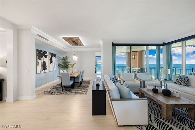 living room with a water view, ornamental molding, a wall of windows, and light hardwood / wood-style flooring