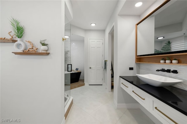 bathroom featuring tile patterned flooring, vanity, and separate shower and tub