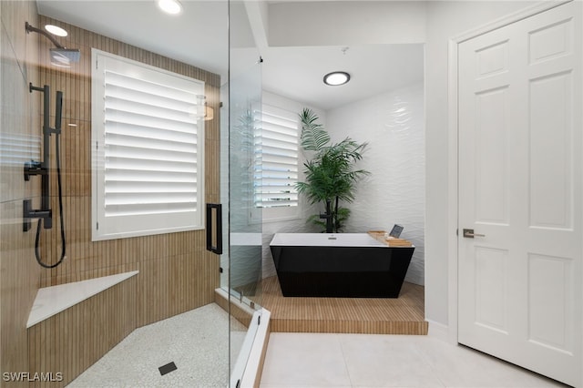 bathroom featuring tile patterned floors and separate shower and tub