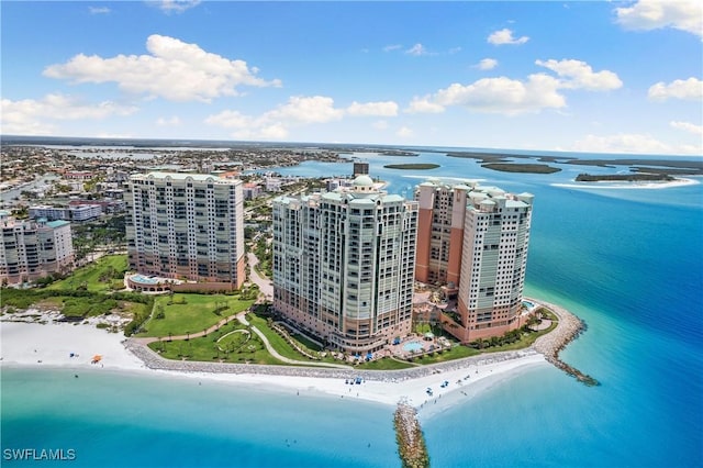 drone / aerial view featuring a beach view and a water view