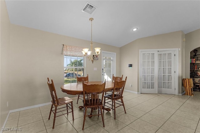 tiled dining room with lofted ceiling, french doors, and an inviting chandelier