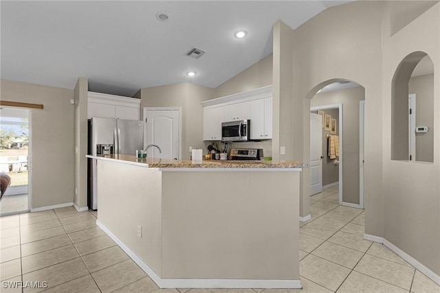 kitchen featuring white cabinetry, light stone countertops, stainless steel appliances, a kitchen island with sink, and light tile patterned flooring