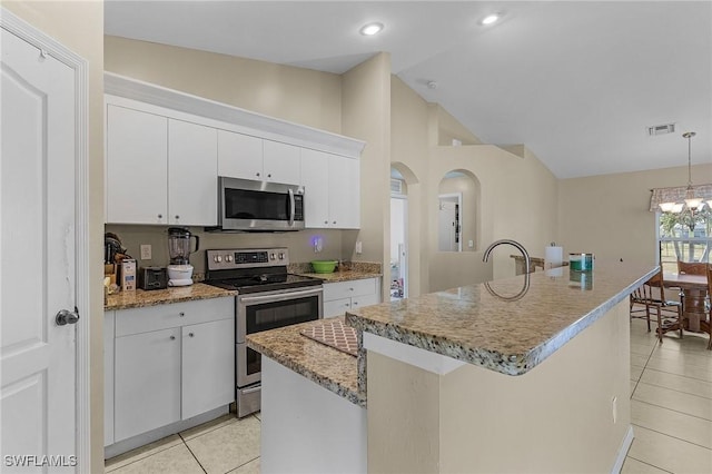 kitchen featuring white cabinetry, stainless steel appliances, and a kitchen island with sink