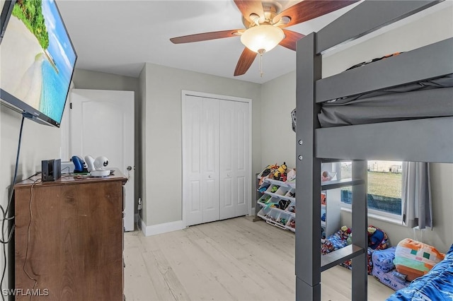 bedroom featuring a closet, light hardwood / wood-style flooring, and ceiling fan