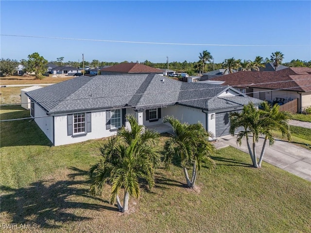 view of front of house with a front yard and a garage