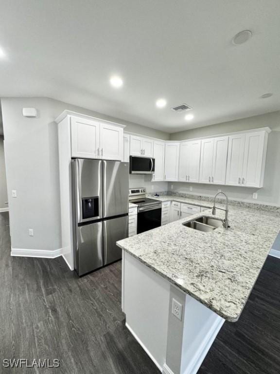 kitchen featuring white cabinets, sink, stainless steel appliances, and dark wood-type flooring