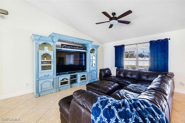 living room featuring ceiling fan, light tile patterned floors, and lofted ceiling