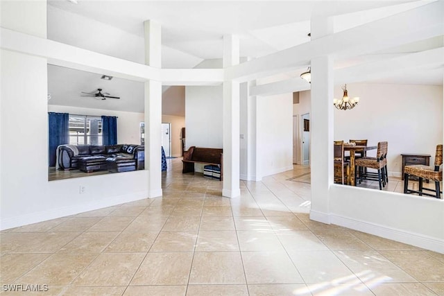 interior space featuring ceiling fan with notable chandelier and high vaulted ceiling