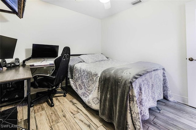 bedroom with ceiling fan and hardwood / wood-style flooring