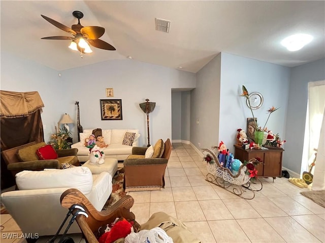 living room featuring ceiling fan, light tile patterned floors, and vaulted ceiling