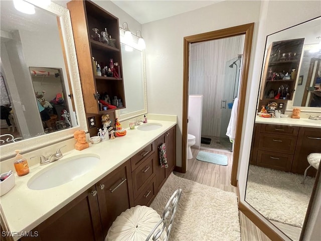 bathroom featuring vanity, toilet, and walk in shower