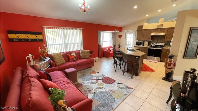 living room with vaulted ceiling, sink, and light tile patterned floors