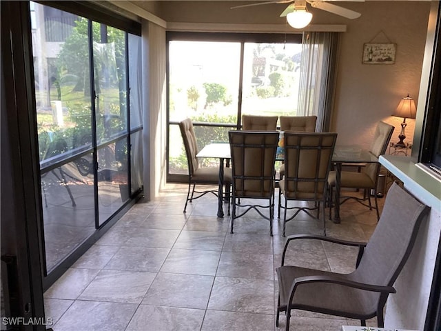 sunroom featuring ceiling fan