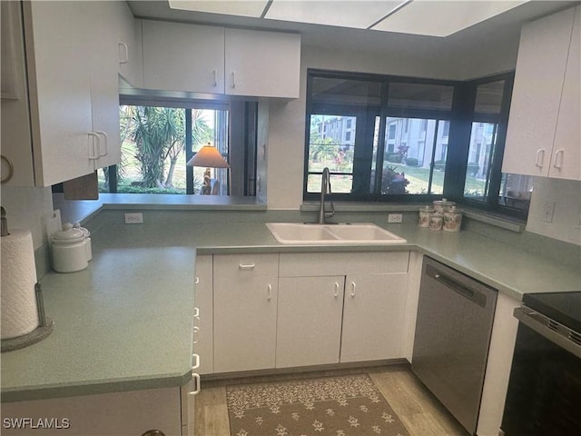 kitchen with light hardwood / wood-style floors, sink, stainless steel appliances, and tasteful backsplash