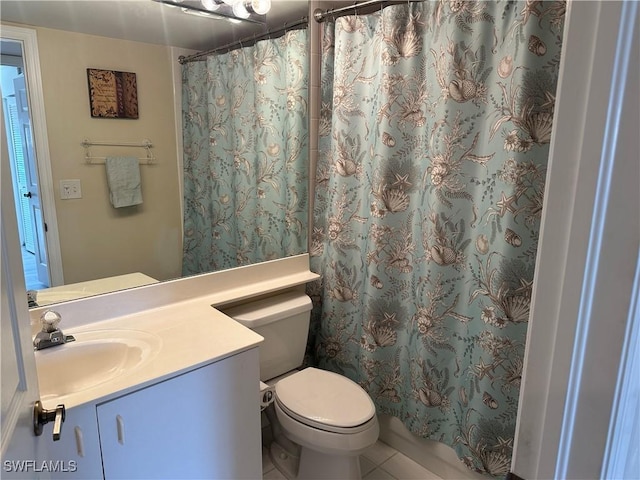 bathroom featuring toilet, a shower with curtain, vanity, and tile patterned floors